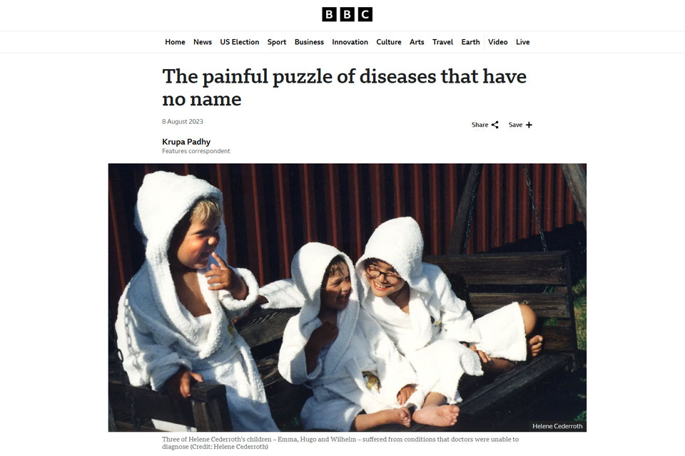 Three children in white bathrobes