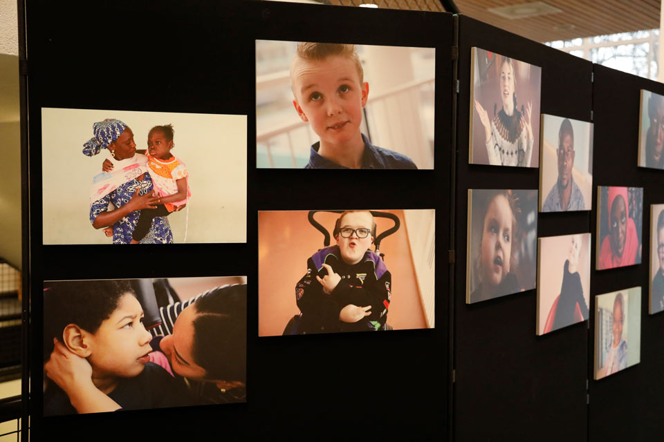 Photographs on photo boards of children and adults