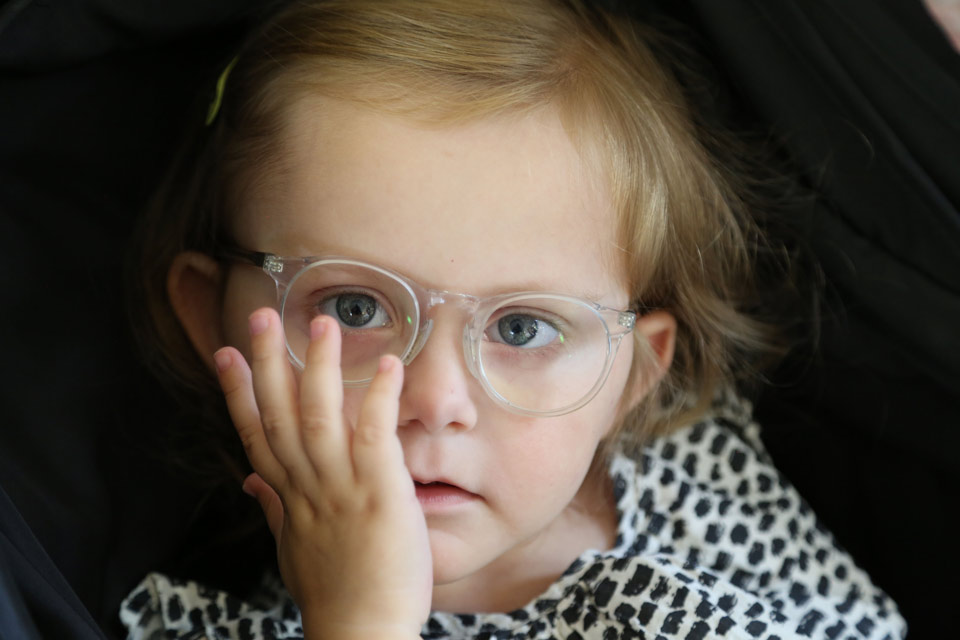 Little girl who corrects her glasses