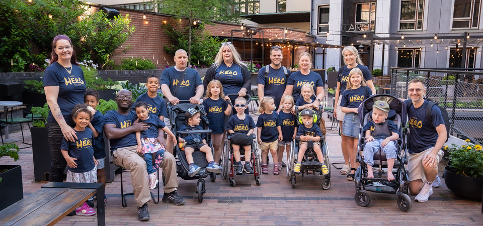 8 adults and 13 children on the photo. All of them had blue T-shirts with Hero  in yellow